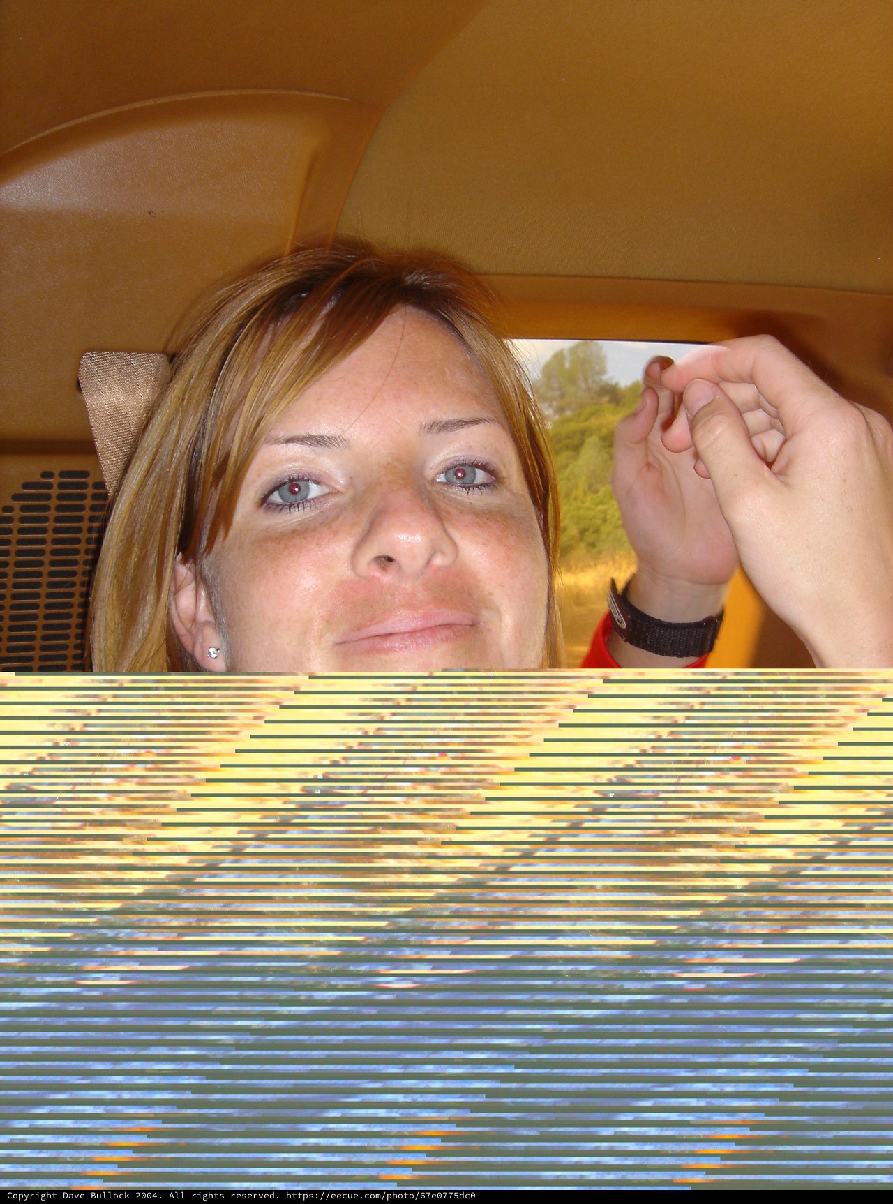 Penelope's Playful Glance in a Yellow Car Interior