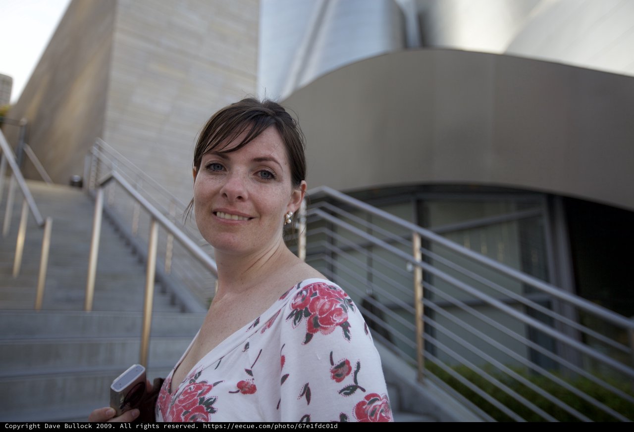 Woman Smiling Outside Modern Concert Hall Steps