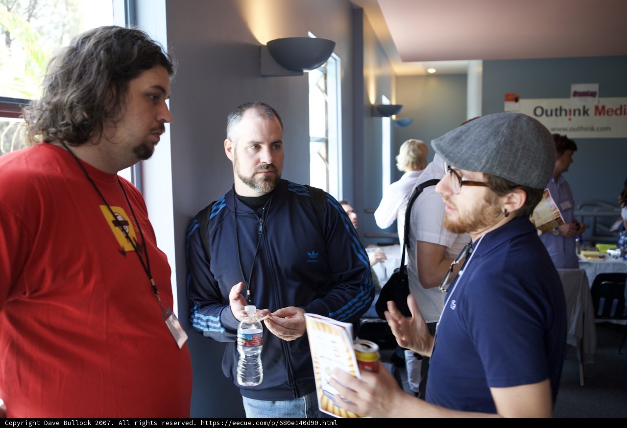 Three Men Discussing Business in a Restaurant