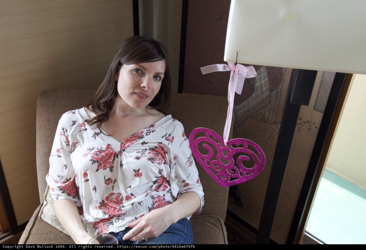 Woman Relaxing in Hotel Room with Valentine Decoration