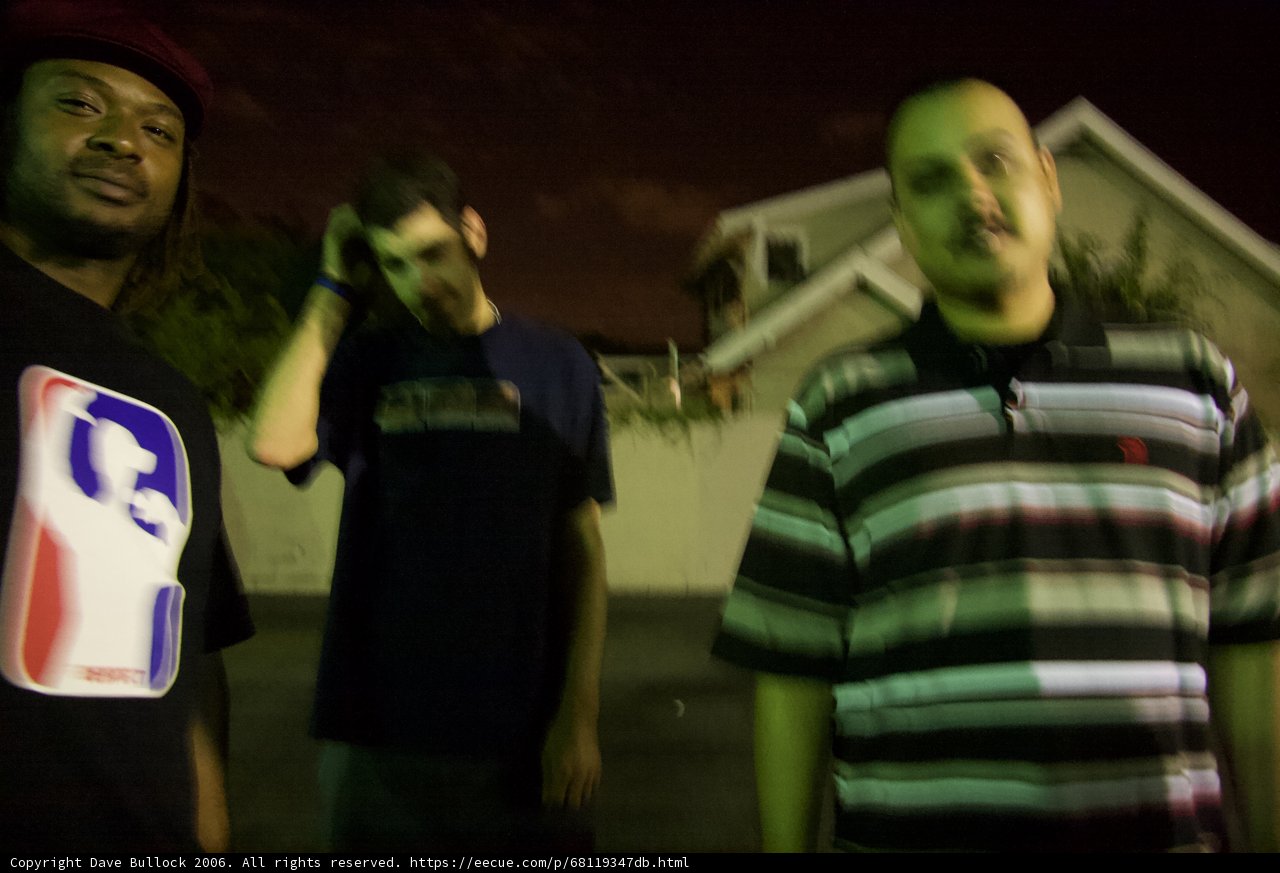 Three Men in Front of Nighttime Building