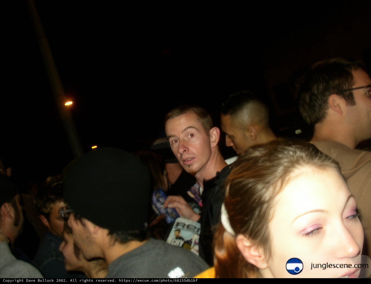 Man in Baseball Cap in Urban Crowd