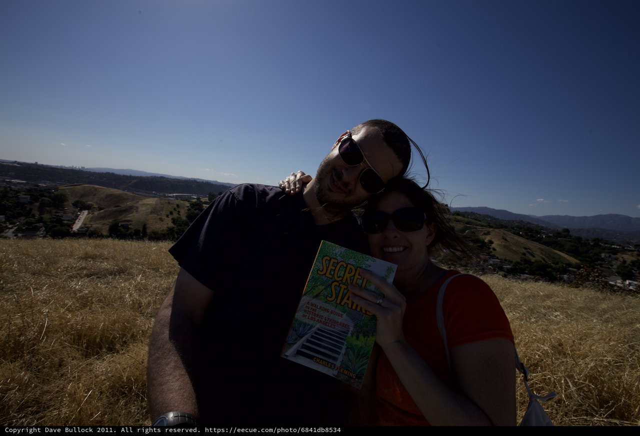 Couple Poses with Secret Stairs Book on LA Hilltop