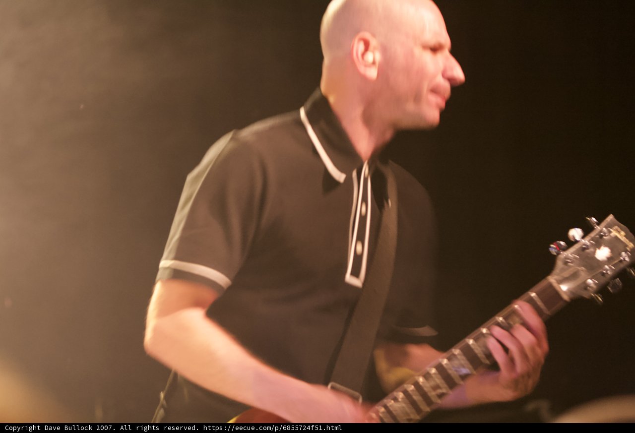 Bald Man Rocks the Electric Guitar on Stage