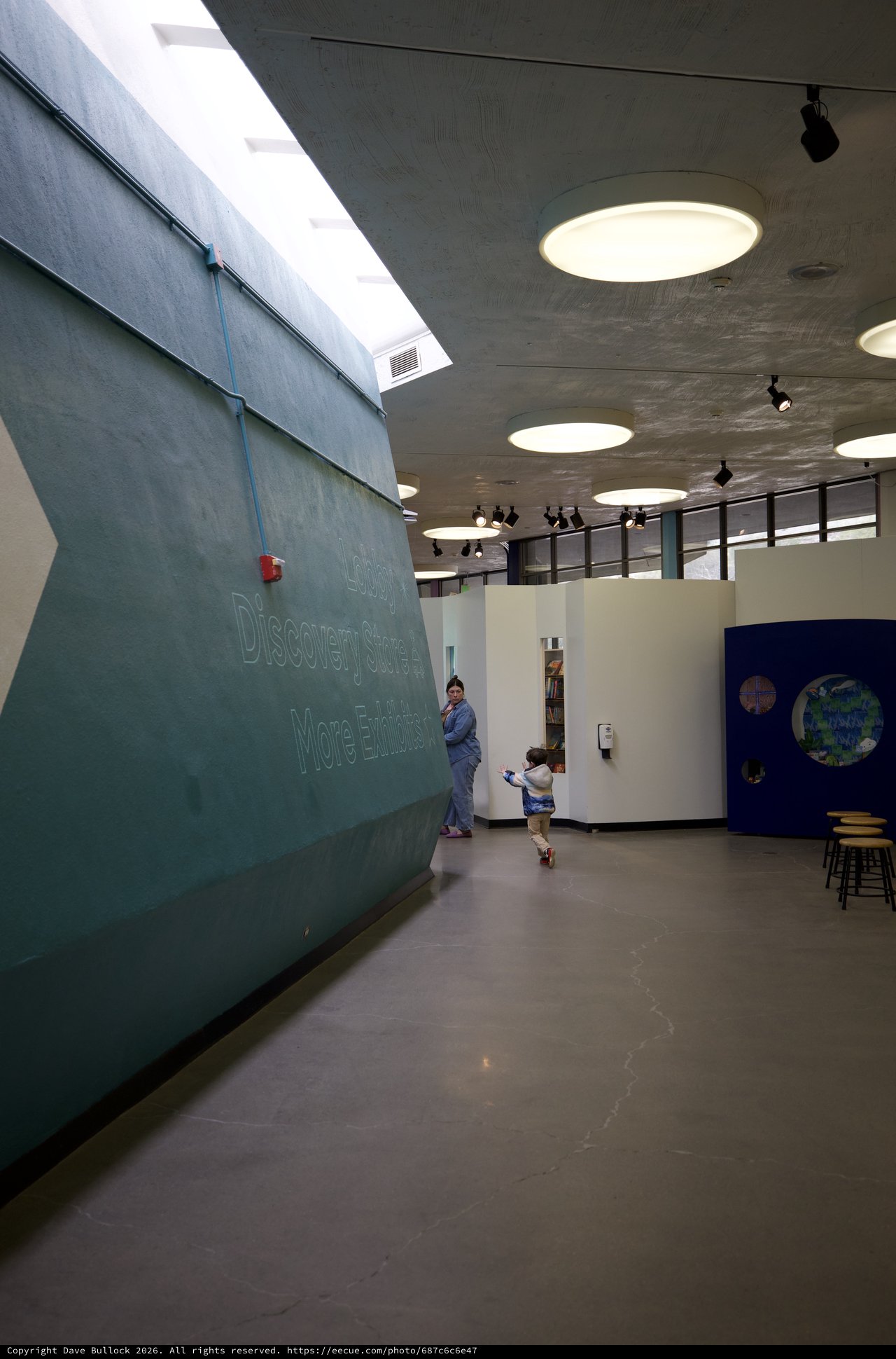 Child Running Through Modern School Hallway with Skylights