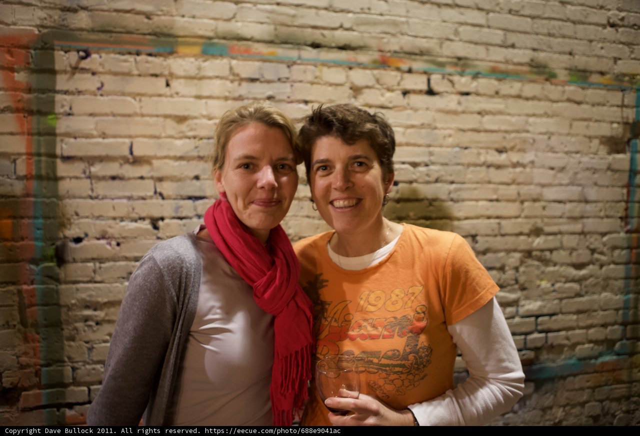 Smiling Women against Brick Wall