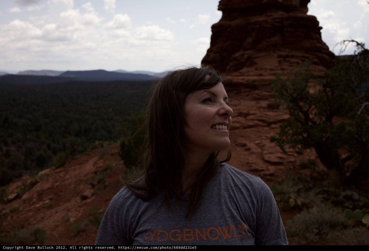 Woman Smiling Atop Red Rock Canyon Overlook