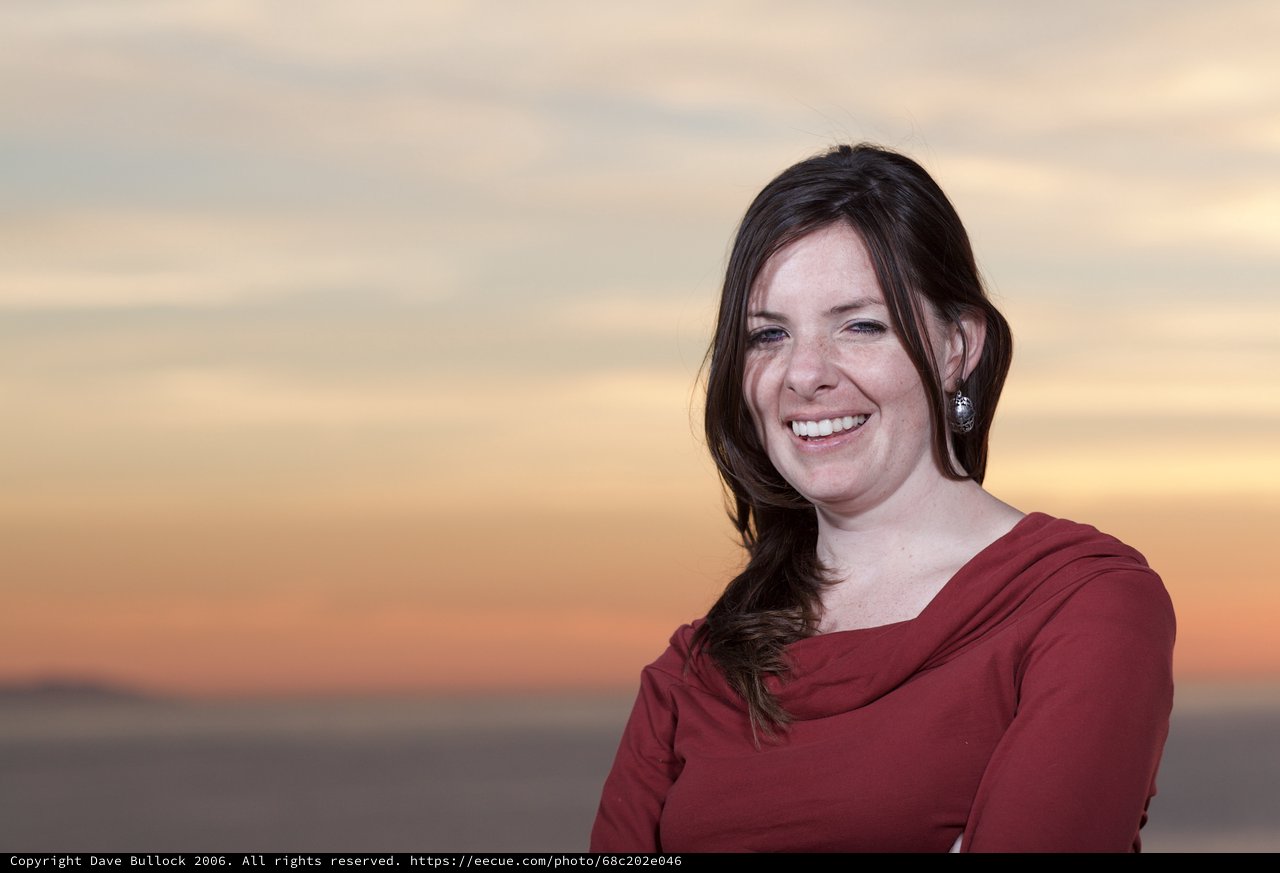 Joyful Woman Laughing at Sunset by the Sea
