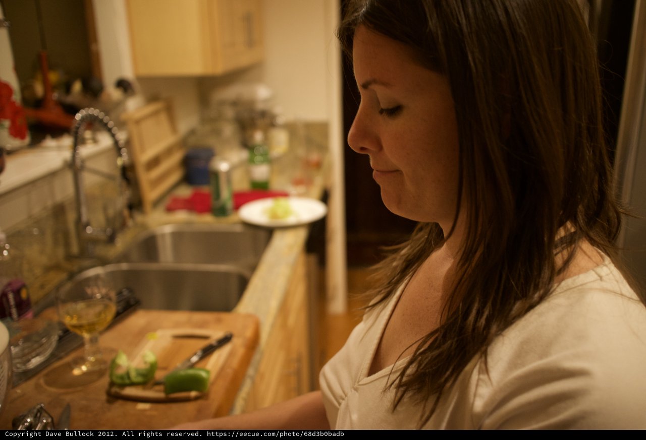Woman Chopping Vegetables in a Cozy Kitchen