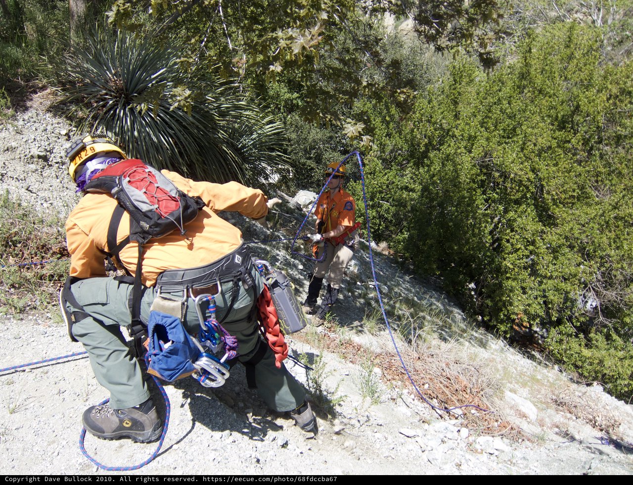 Search and Rescue Team Rappelling Down Rocky Cliff