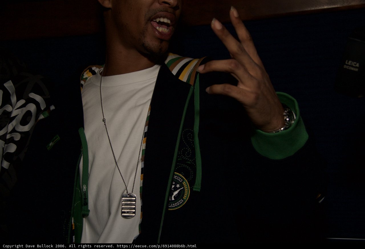Green Jacket, White Shirt, and a Cell Phone