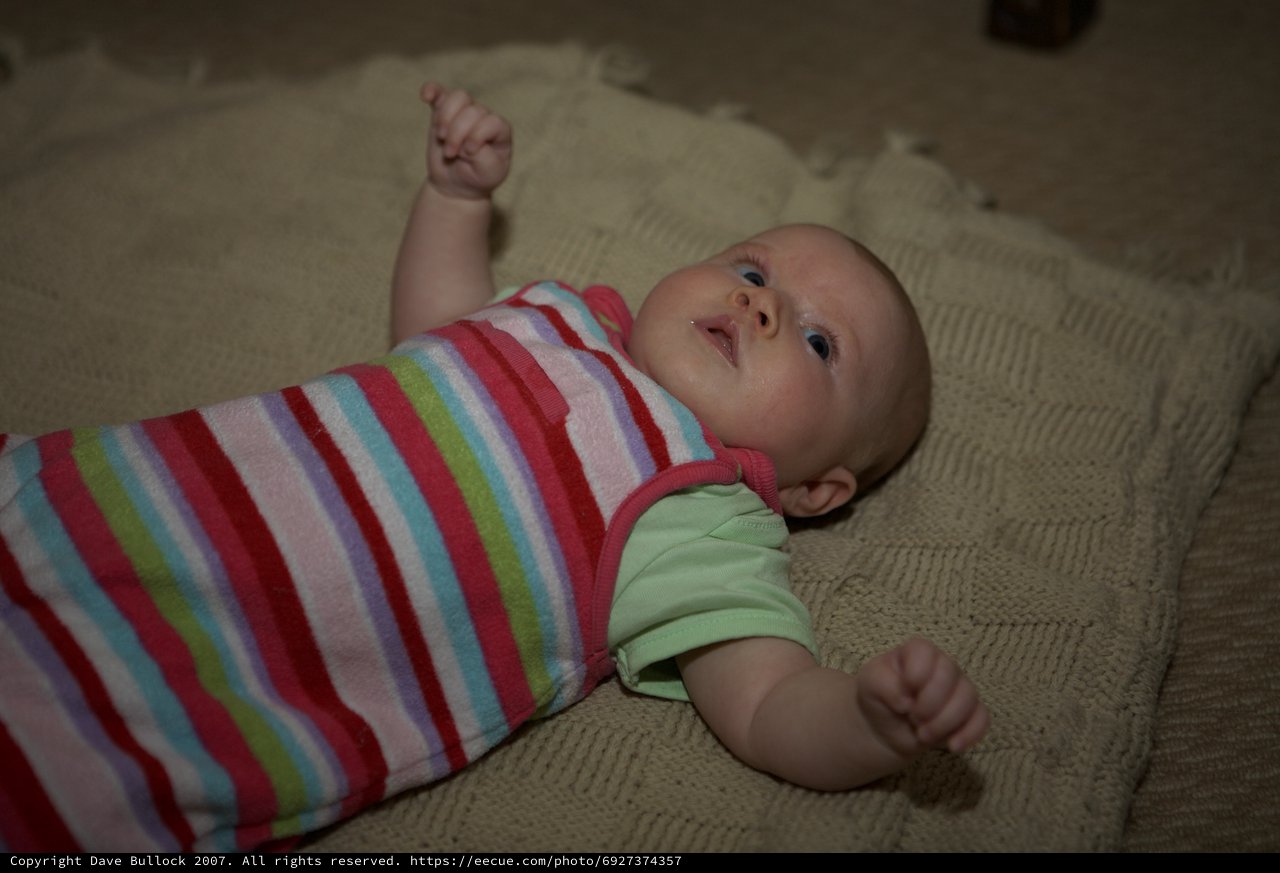 Curious Baby Lying on Knit Blanket Floor