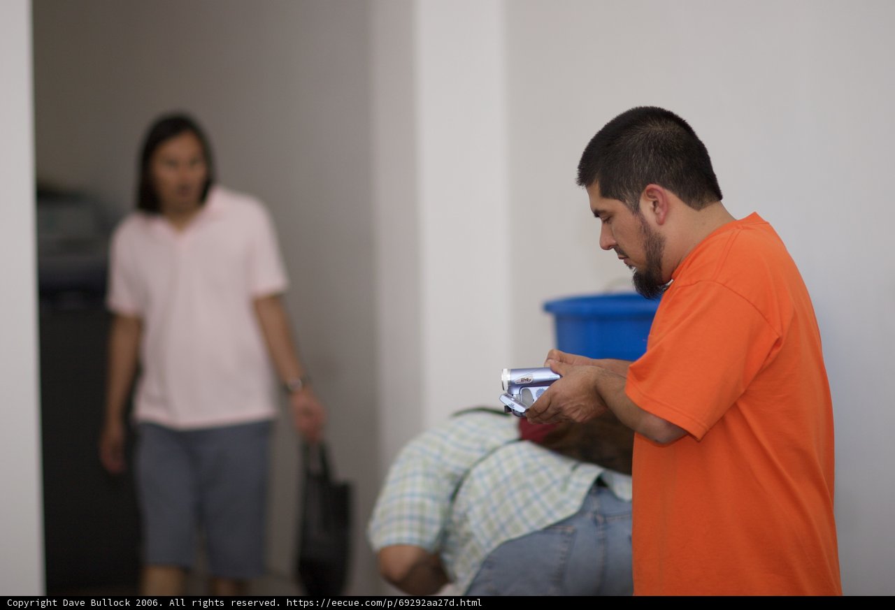 Man in Orange T-Shirt with a Gun