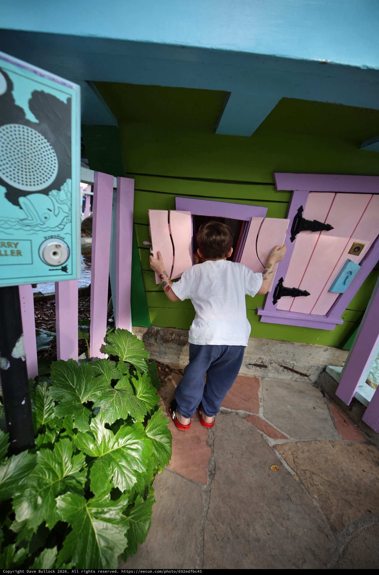 Child Playing at Colorful Miniature Playhouse