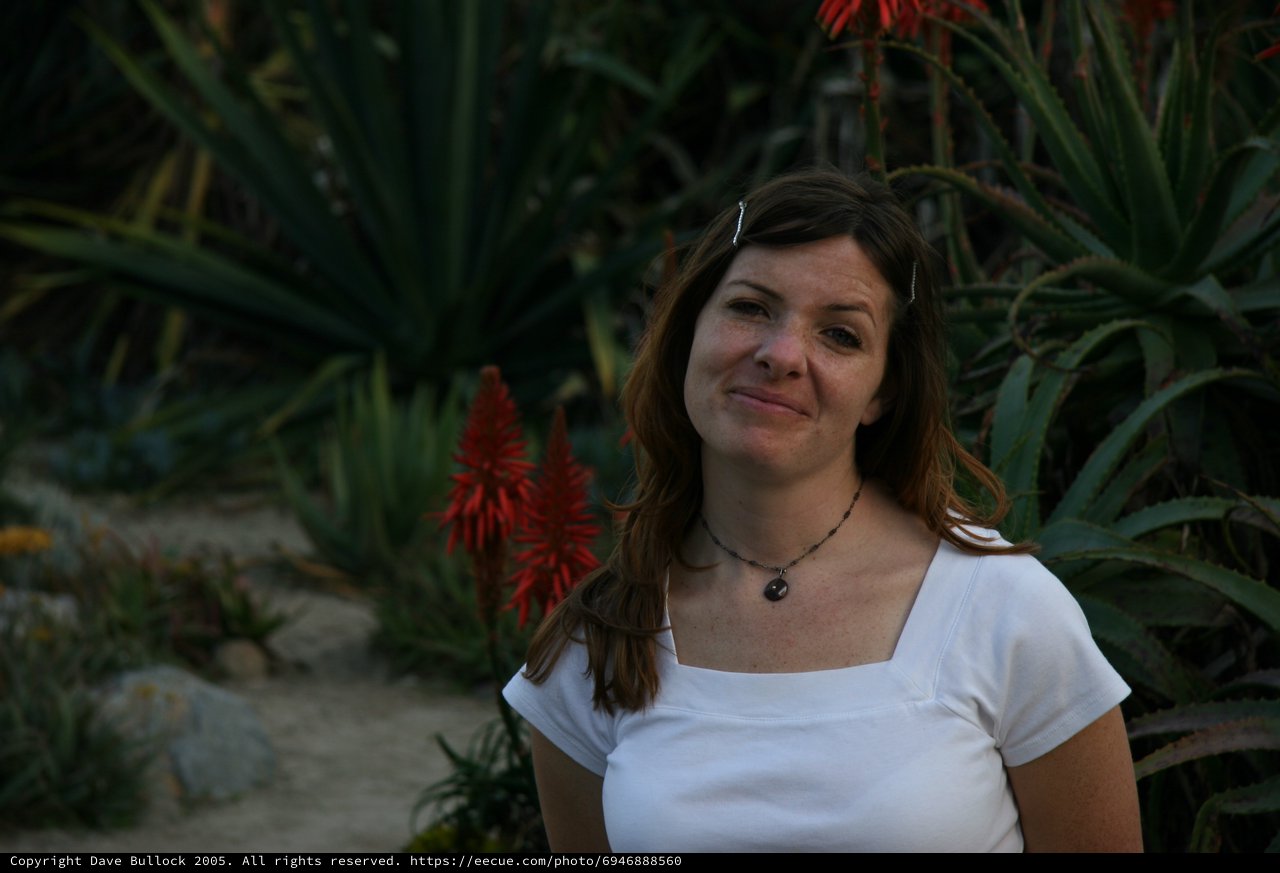 Woman Smiling in Lush Desert Garden Setting