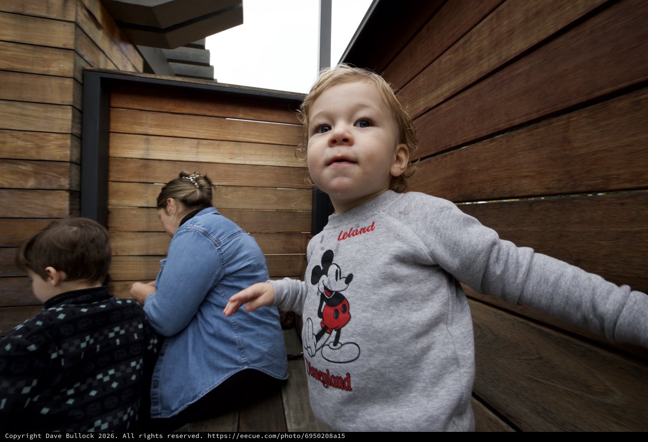 Toddler in Mickey Mouse Sweatshirt Exploring Indoor Space