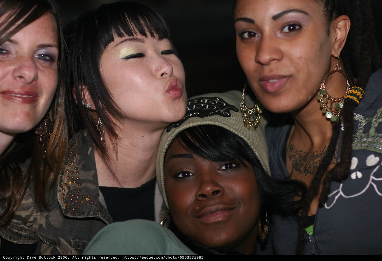 Four Friends Posing Together at a Nightlife Event