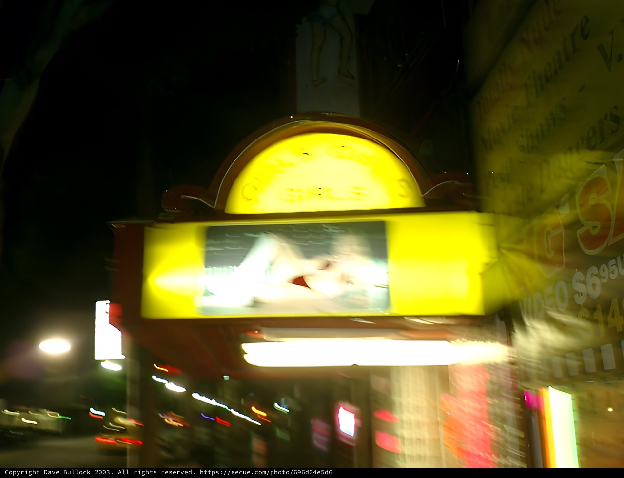 Motion-Blurred Urban Night Scene with Glowing Billboard