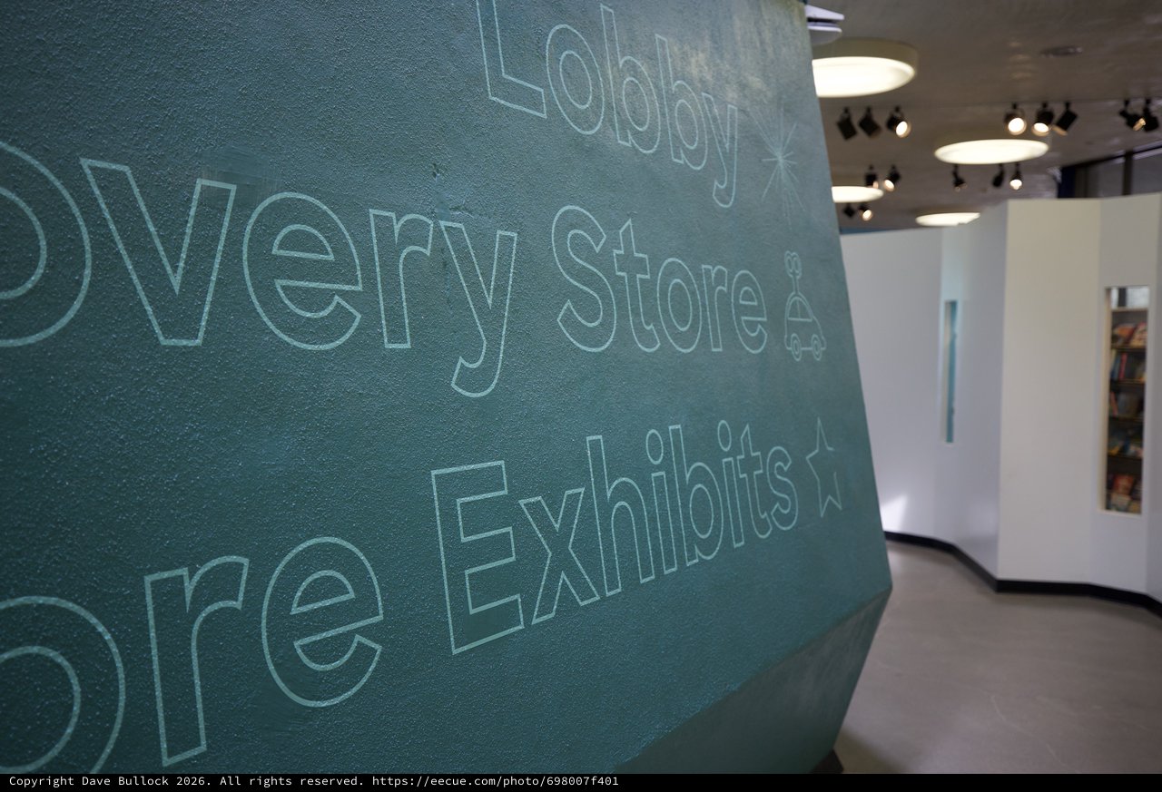 Contemporary Museum Lobby with Textured Teal Wall Typography