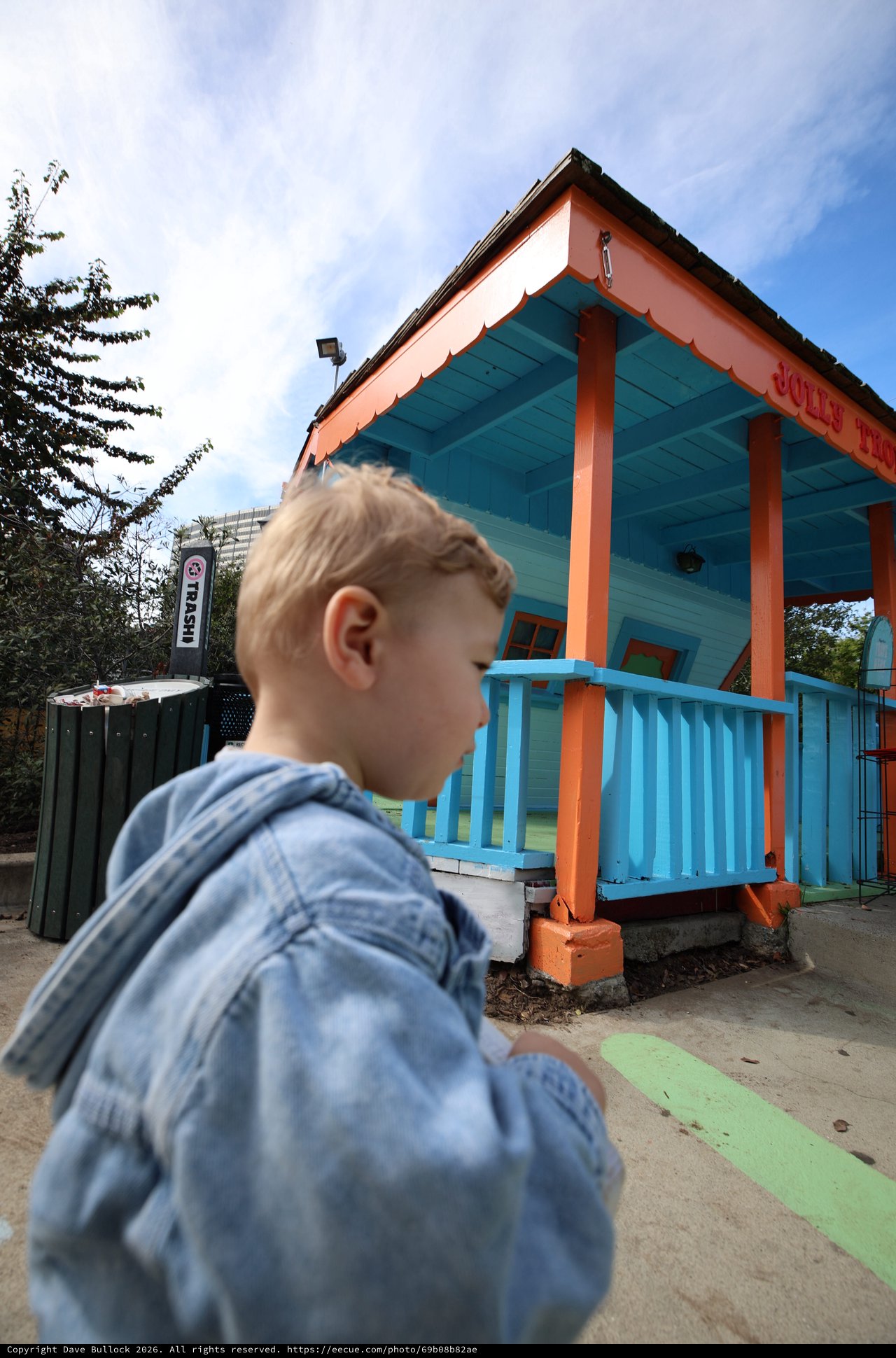 Child Gazes at Vibrant Turquoise and Orange Playhouse