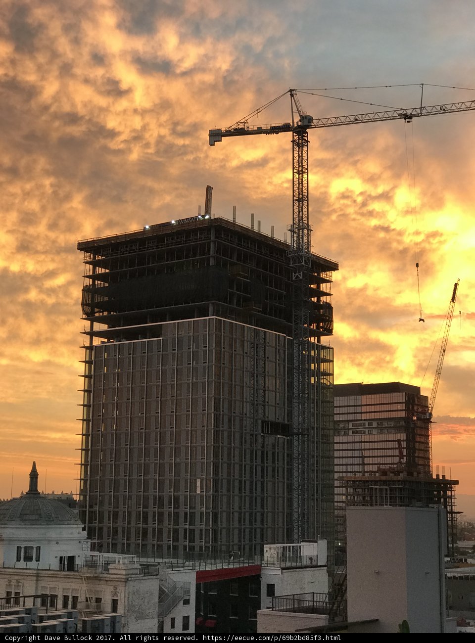Towering Construction in the City at Sunset
