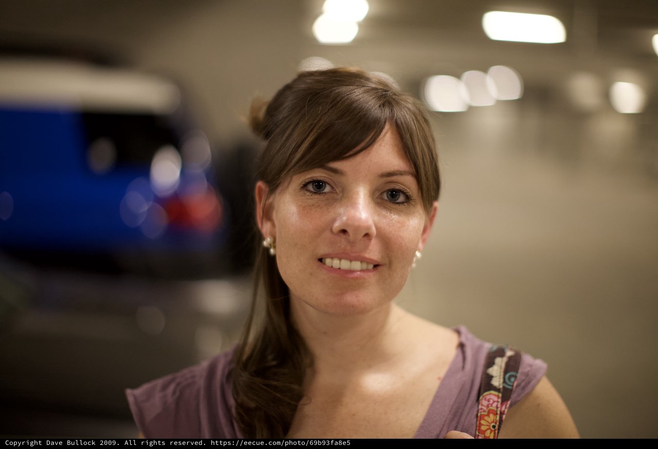 Smiling Woman in Dimly Lit Parking Garage