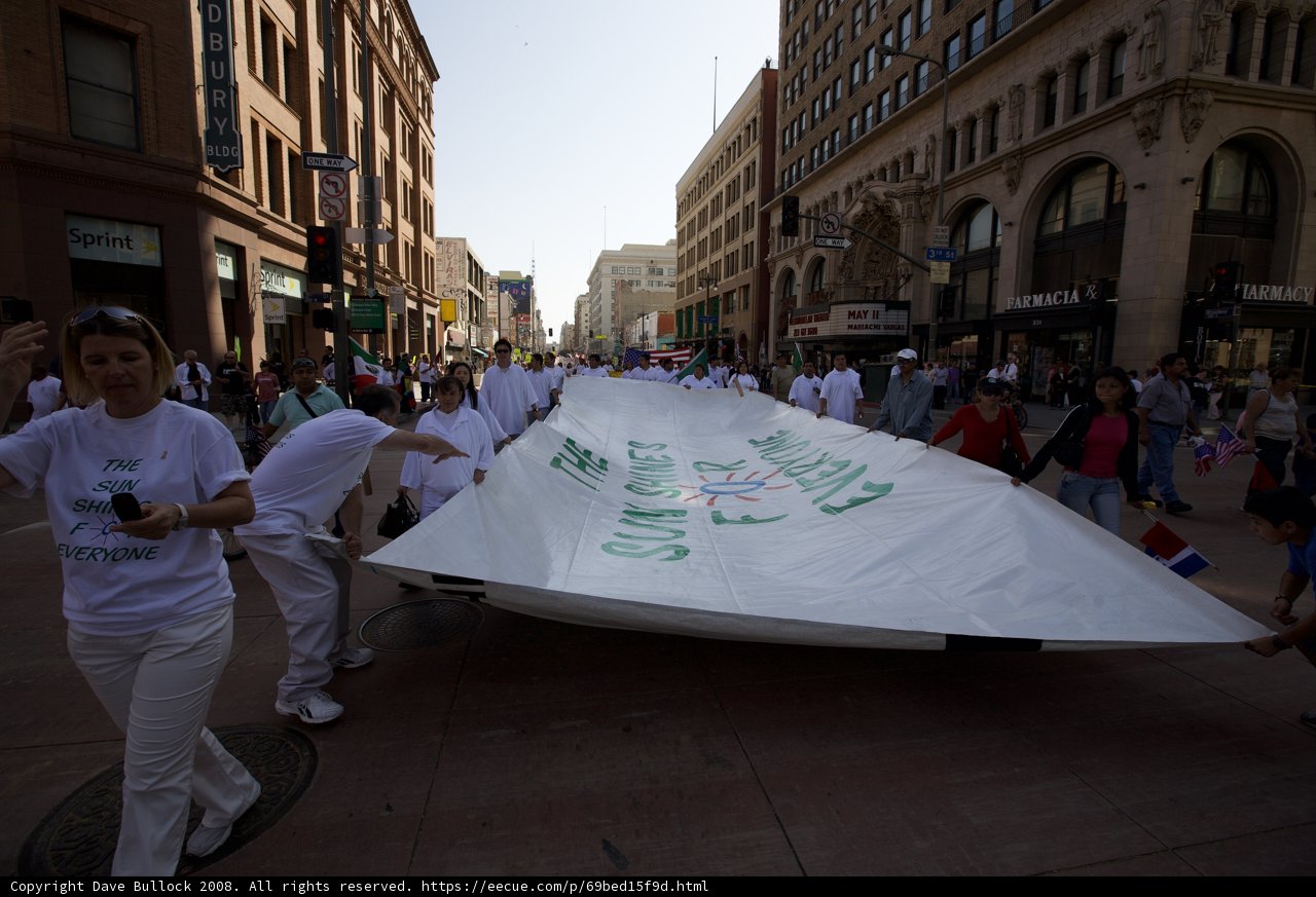 May Day Rally: People Marching with a Banner