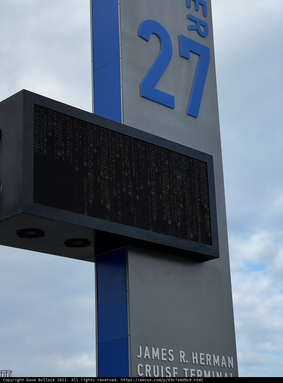 James Bernard Cruise Ship Terminal Sign Amidst Cloudy Skies