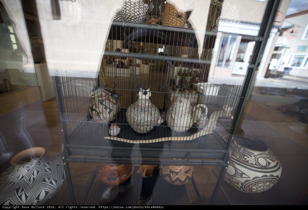 Decorated Pueblo Pottery Display Behind Wire Cage