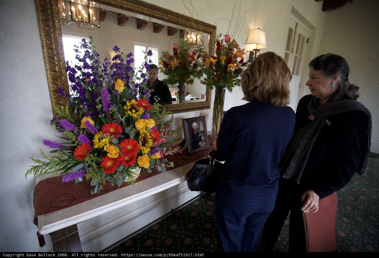 Women Admiring Flower Arrangements in Memory of Grandma