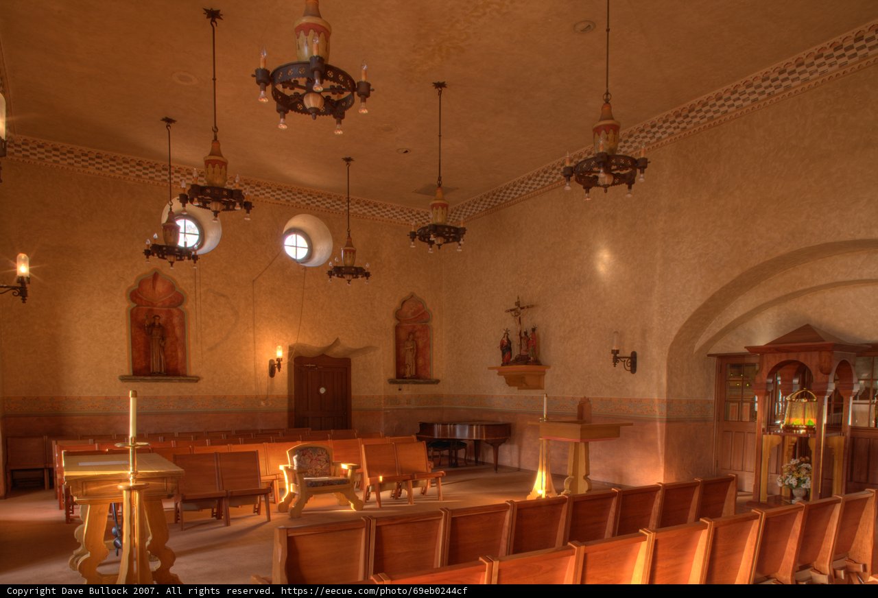 Church Interior with Elegant Chandeliers and Wooden Pews