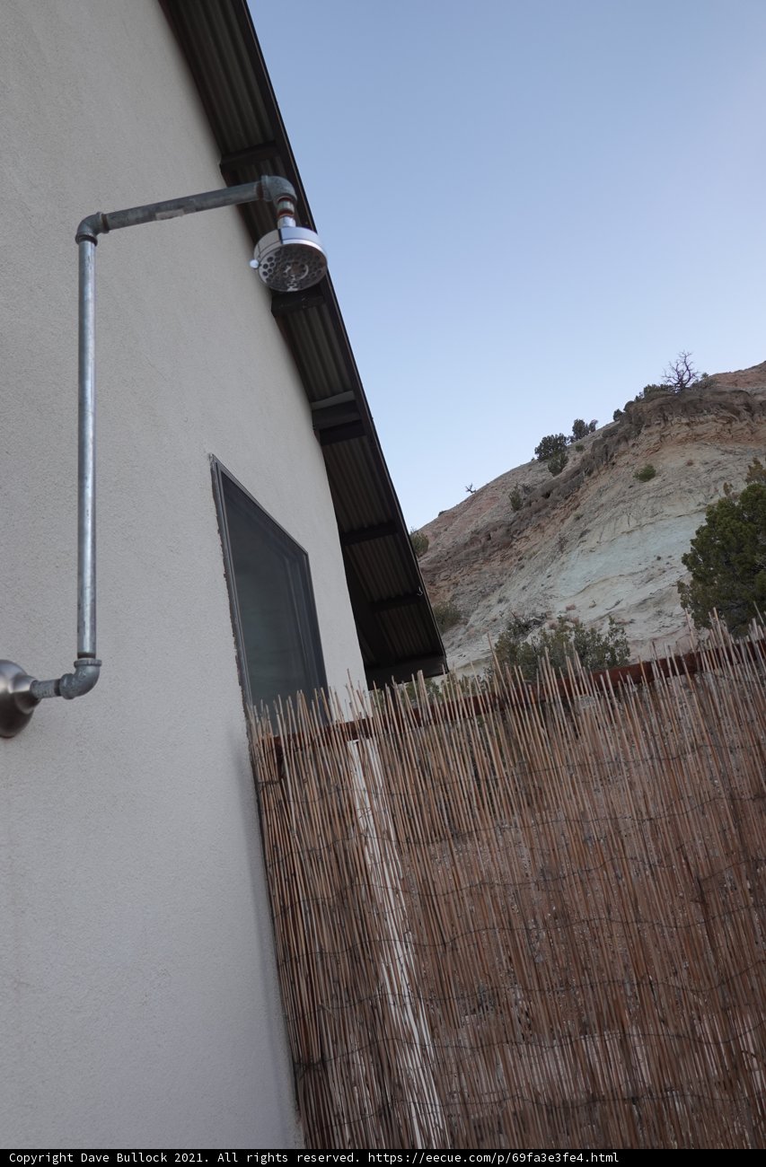 Metal Shower Head in a Rustic Outdoor Bathroom
