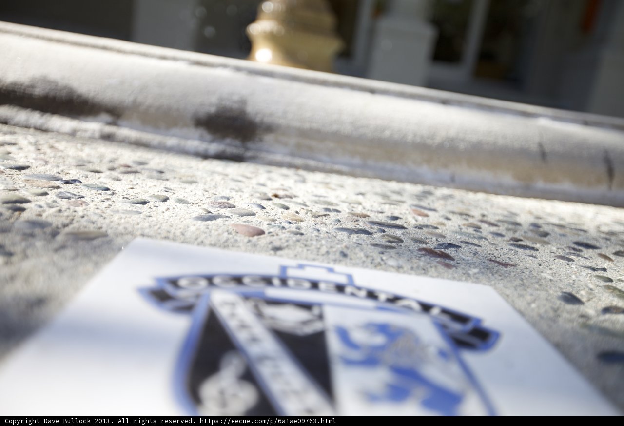 Blue and White Logo on Cement Wall