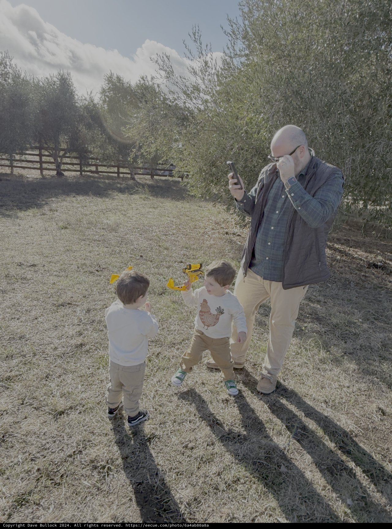Father and Children Playing in Countryside Field