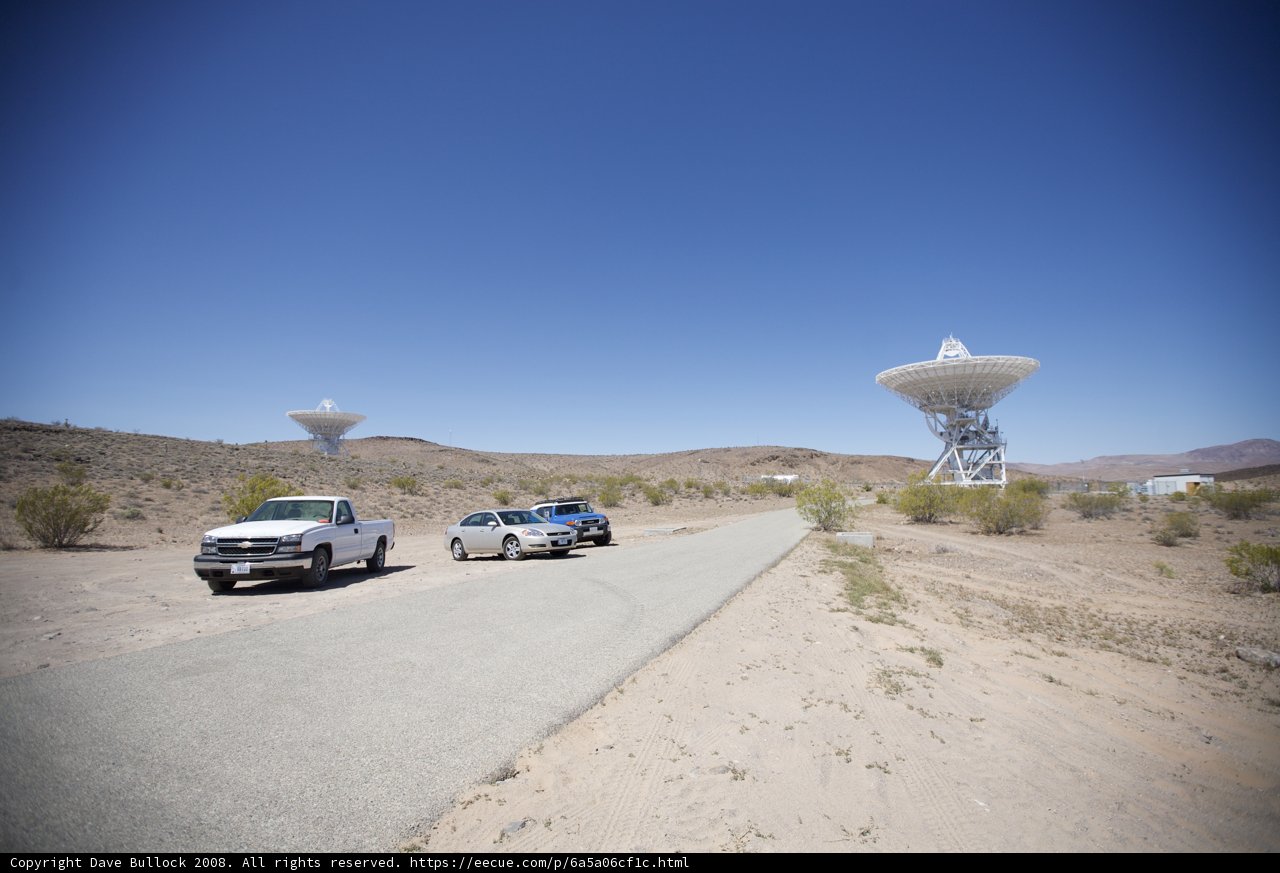 Parked Trucks Near Large Antennas