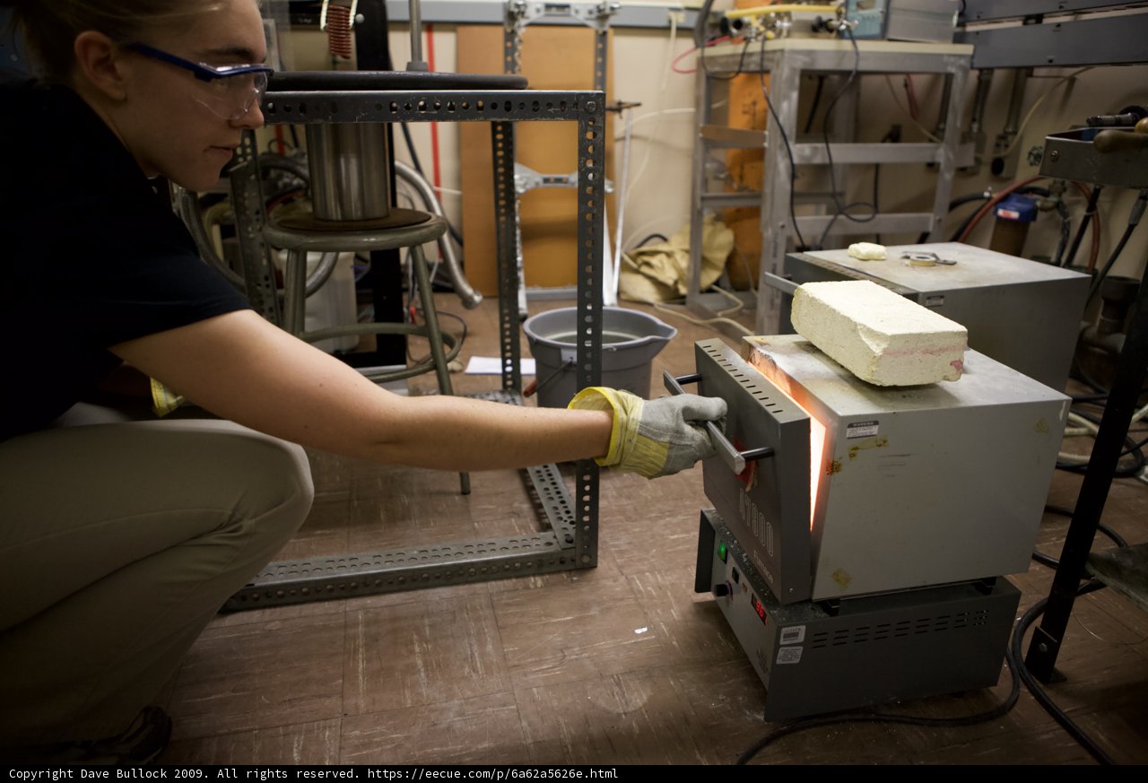 Lab Worker Operates Machine in Industrial Factory