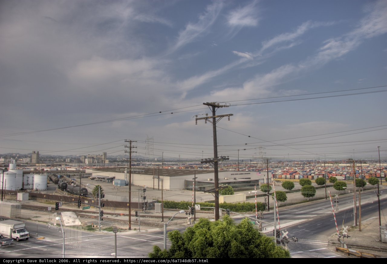Urban Intersection with Power Lines and Blue Sky