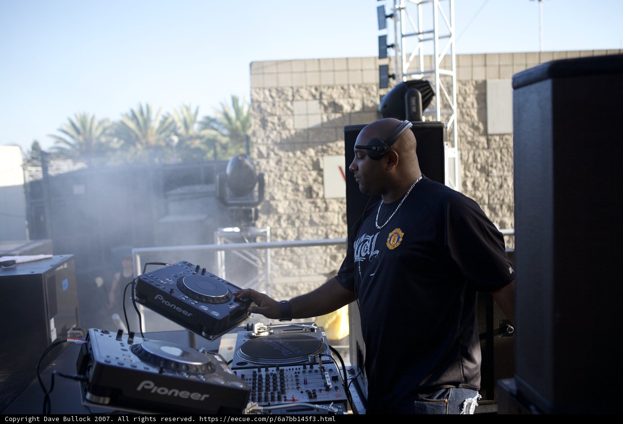 DJ mixes the beat under the sunny skies