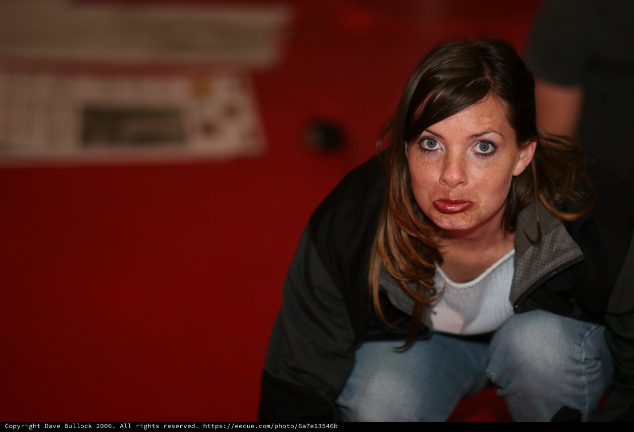Curious Woman Crouching at BarCamp Event 2006