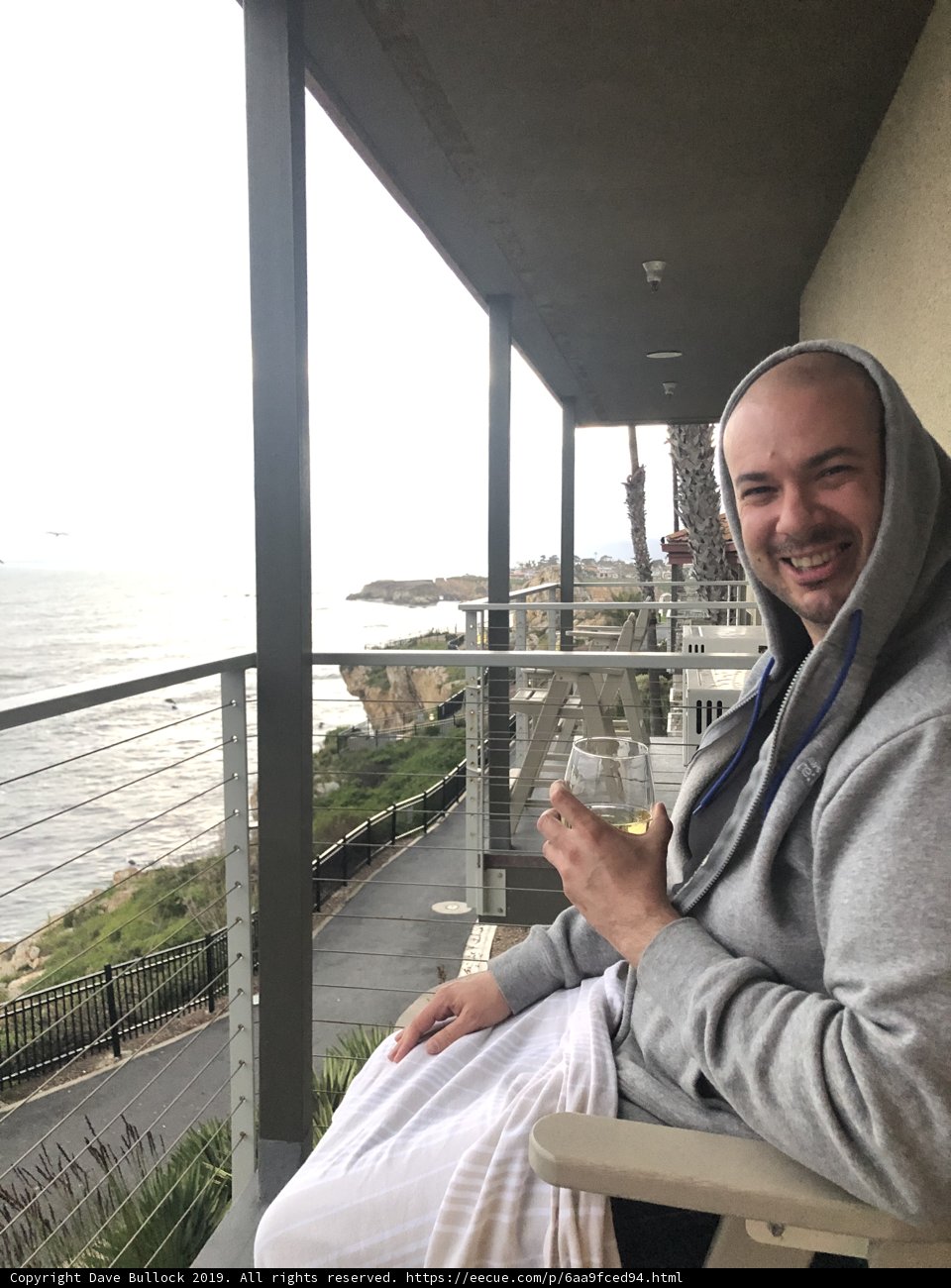 A Man and his Drink on the Balcony
