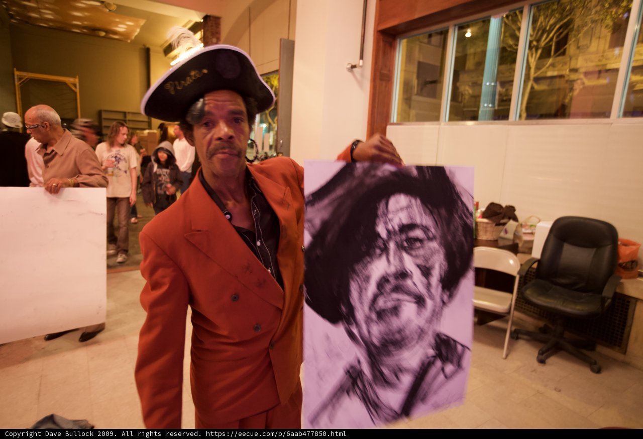 Suit-clad Rustee Allen Holds a Drawing of a Man