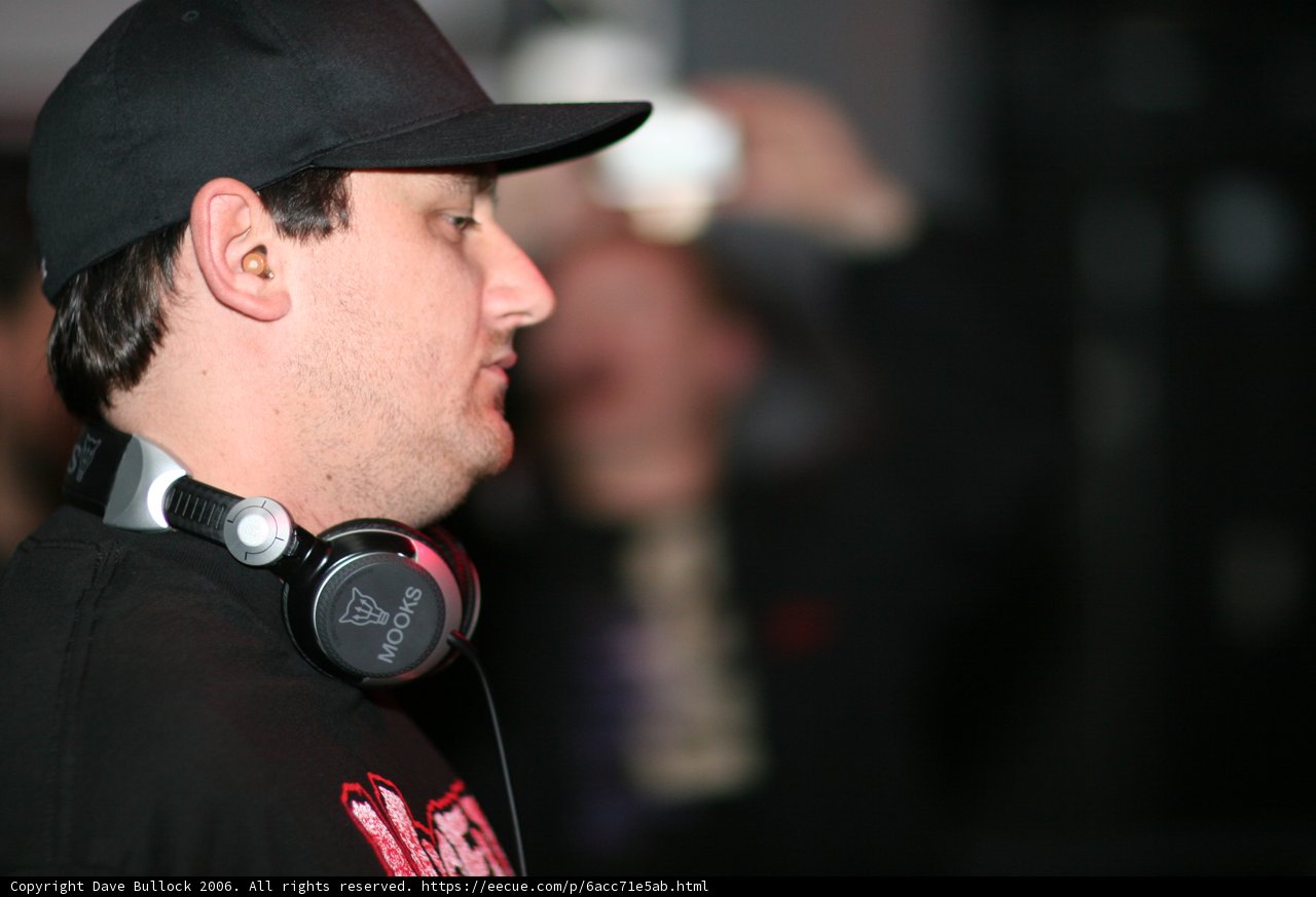 Black Shirted Man with Baseball Cap and Headphones