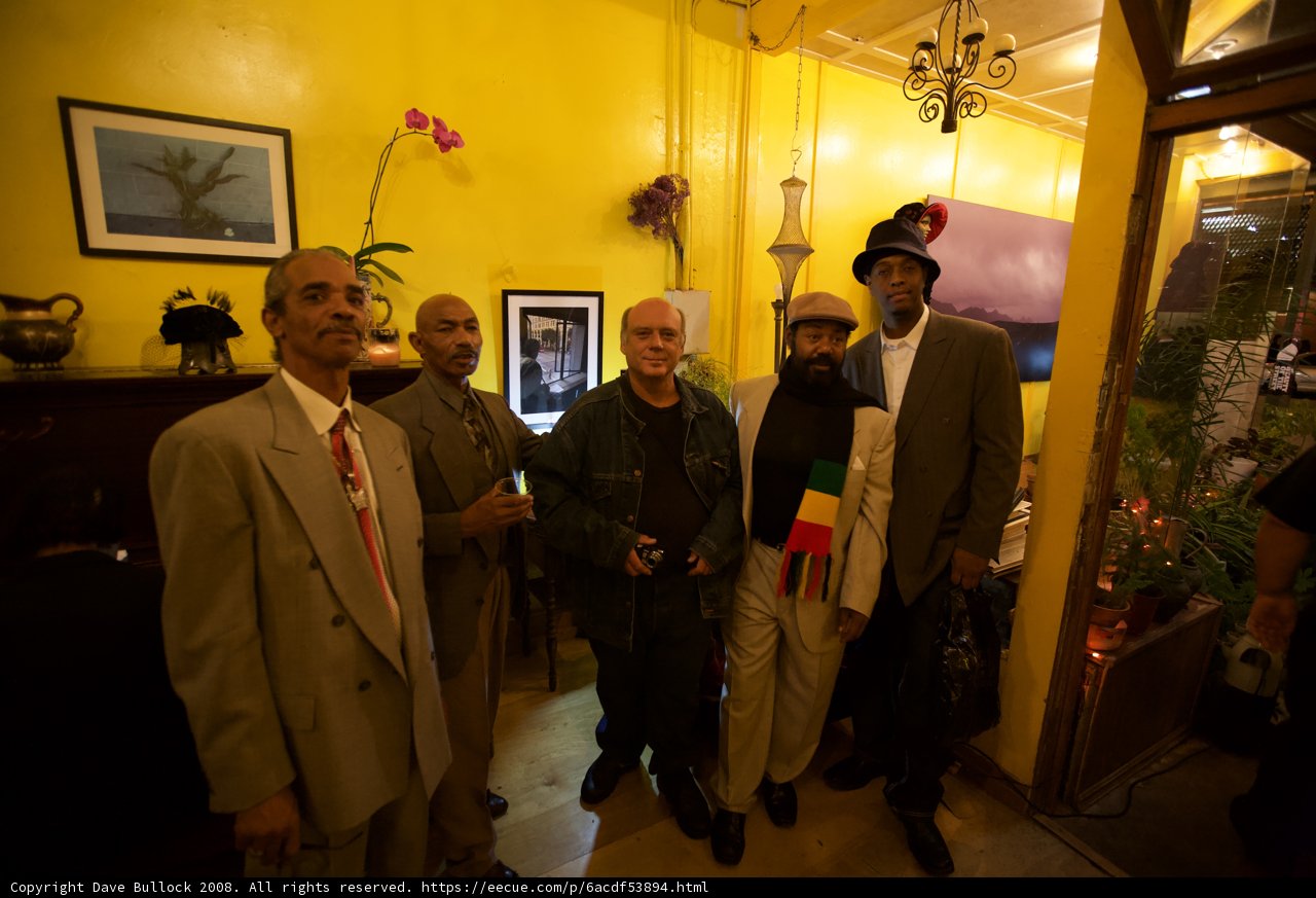 Group of Men in Formal Attire Standing Together in a Room