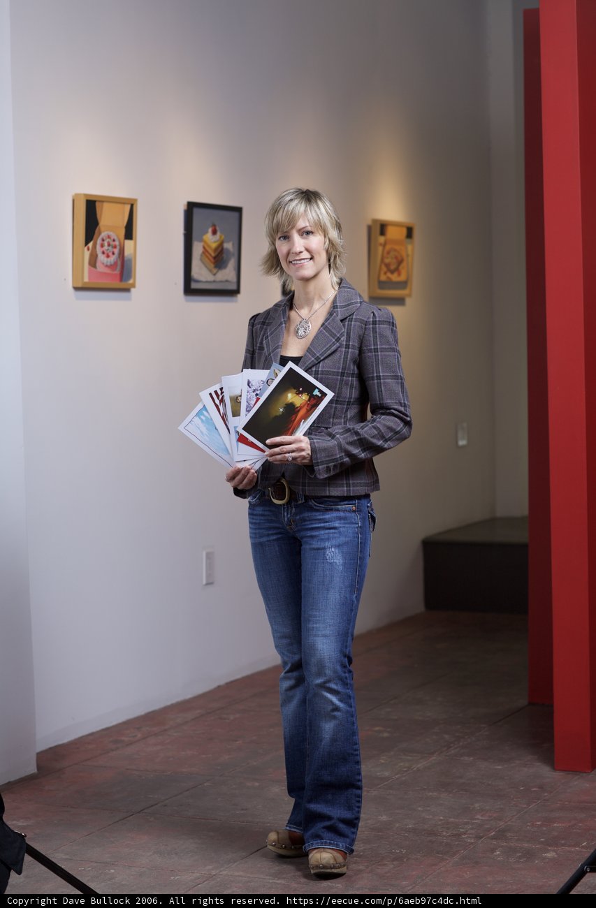 Woman in Jeans and Blazer Reading Book in Art Gallery