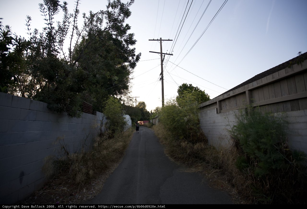 City Alley with Power Lines and Fence