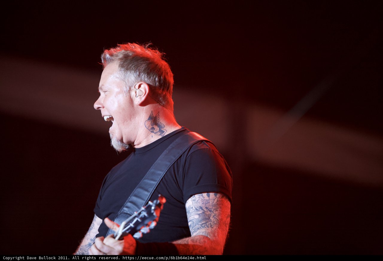Tattooed man rocks the stage with guitar at Big Four Festival