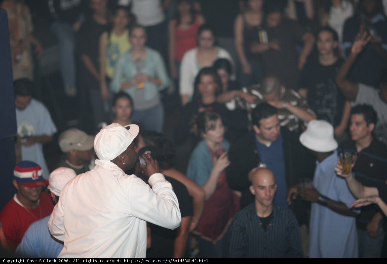 Man in White Shirt Stands Out in Urban Crowd