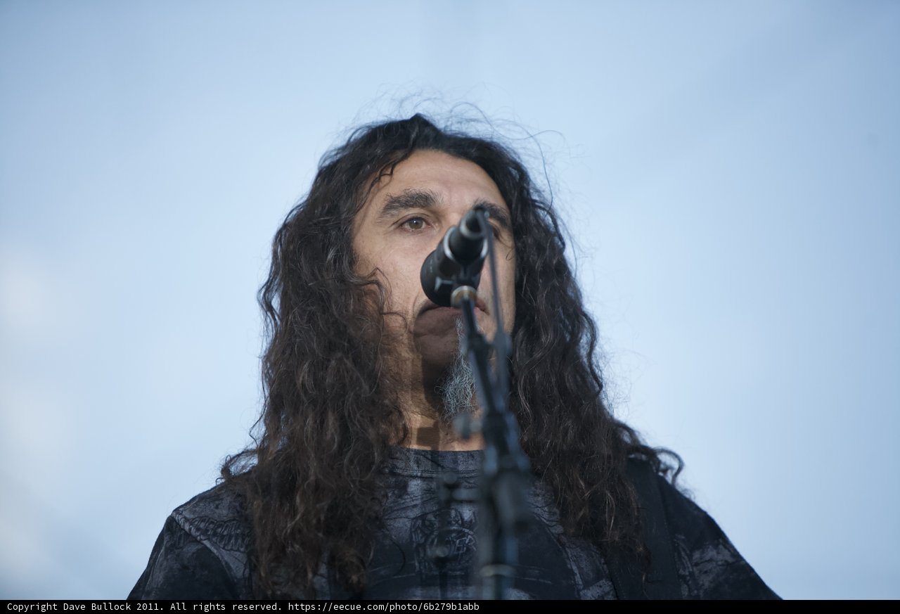 Tom Araya taking the stage with his microphone