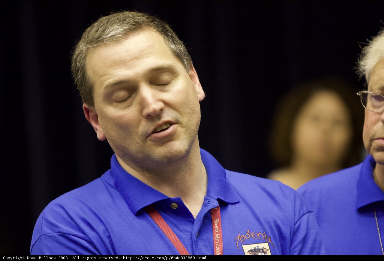 Men in Blue Shirts Concentrating on Something