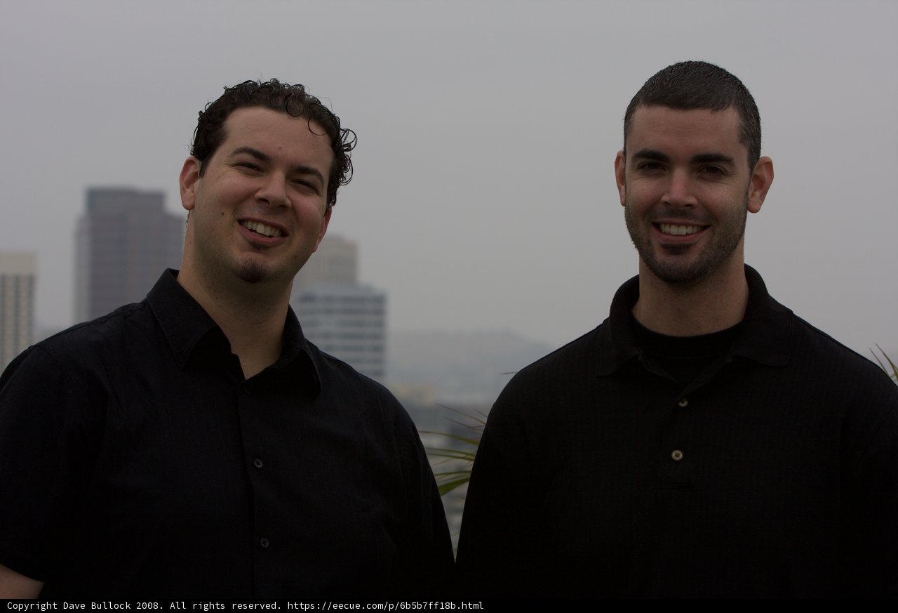 Two Happy Men in Black Shirts Outdoors